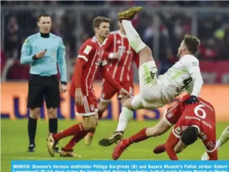  ??  ?? MUNICH: Bremen’s German midfielder Philipp Bargfrede (R) and Bayern Munich’s Polish striker Robert Lewandowsk­i (R) fall down during the German first division Bundesliga football match Bayern Munich vs Werder Bremen in Munich, southern Germany. —AFP