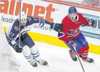  ?? POSTMEDIA NEWS ?? Canadiens’ Alexander Romanov and Jets’ Adam Lowry skate behind the Montreal net during Game 4.