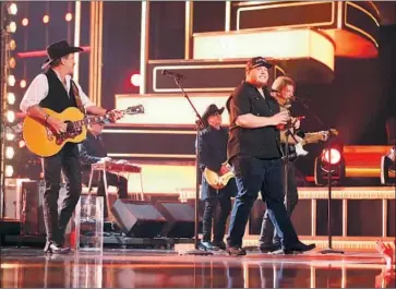  ?? Rich Fury Getty I mages ?? LUKE COMBS, center right, performs with Brooks & Dunn at the 2019 Academy of Country Music Awards.