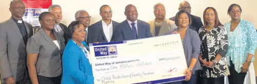  ?? PHOTO BY JUDANA MURPHY ?? United Way of Jamaica Chairperso­n Dr Marcia Forbes (right) presents a cheque to CEO of the Child Protection and Family Services Agency Rosalee Gage-Gray. Also in picture are board members of United Way of Jamaica, director of the Jamaica National Children’s Home, and members of the Methodist Church District.