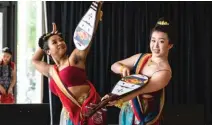  ?? ASHLEE REZIN / SUN-TIMES PHOTOS ?? Brianna Tong (left) and instructor Hana Liu, of Chicago’s Yin He Dance company, perform “Playing the Pipa in Reverse” at a recent Navy Pier event.