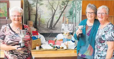  ??  ?? Dianne St Merat, left, Jocelyn McKay and Rosemary Moss of the Rua Roa Women’s Institute who took out first prize for the showcourt section which had a theme of early settlers.