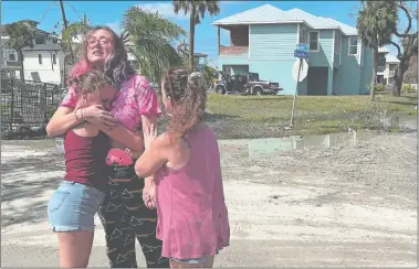  ?? MOLLY HENNESSY-FISKE/WASHINGTON POST ?? Kristelle Reed comforts Courtney Schneider after they discovered what they lost in Fort Myers Beach on Thursday. Reed said her apartment in Fort Myers Beach had flooded, killing her pet fish. Schneider watched her car float away in the storm surge.