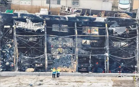  ?? Jay L. Clendenin Los Angeles Times ?? THE REMAINS of the Oakland warehouse known as the Ghost Ship are seen Monday after a fire that killed 36 people there last week.