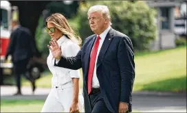  ?? ALEX WONG / GETTY IMAGES ?? U.S. President Donald Trump, seen here recently with first lady Melania Trump, urged Democrats to support border security funding.
