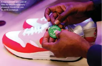  ?? ?? A tag is placed on a pair of Nike Air Max Anniversar­y shoes at StockX on Jan. 10, 2018, in Detroit.