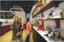  ??  ?? GUESTS ARE seen inside the Italian coffee roasting company illycaffe’s flagship store in downtown Milan, Italy, Sept. 15.