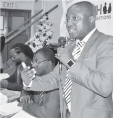  ??  ?? Reserve Bank of Zimbabwe official Mr Khumbulani Shirichena (right) answers questions from the public during a National University of Science and Technology (Nust) public lecture on bond notes at the Small City Hall in Bulawayo yesterday. Listening next...