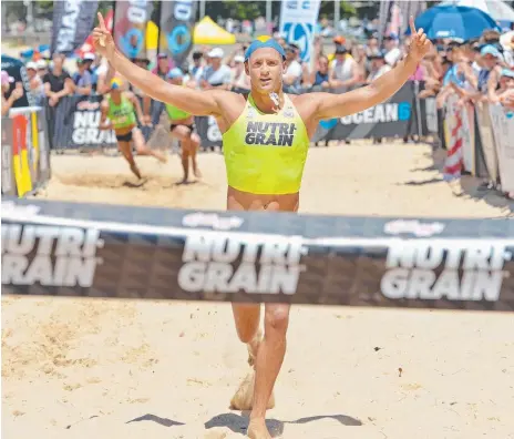  ??  ?? T.J. Hendy in his first Kellogg's Nutri-Grain Ironman event win at Queensclif­f Beach, and (below), on the surf ski leg. Pictures: TROY SNOOK