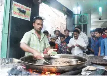  ??  ?? A vendor makes beef kebabs at the Tundey Kebabi Restaurant in Lucknow. (AFP)