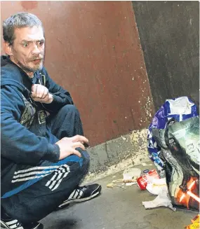  ??  ?? Resident John Cree beside a pile of rubbish in the close at Arklay Street.