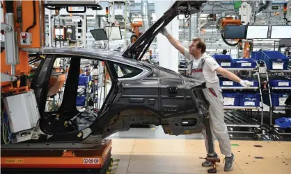  ??  ?? Workers assemble Audi sedans on an assembly line at the Ingolstadt plant. Photograph: Andreas Gebert/Getty Images