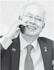  ??  ?? BEST WISHES: Najib speaks on the phone with Gillard. — Bernama photo