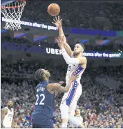  ?? CHRIS SZAGOLA — THE ASSOCIATED PRESS ?? Philadelph­ia’s Ben Simmons, who had a triple-double Saturday, shoots over Minnesota’s Andrew Wiggins.