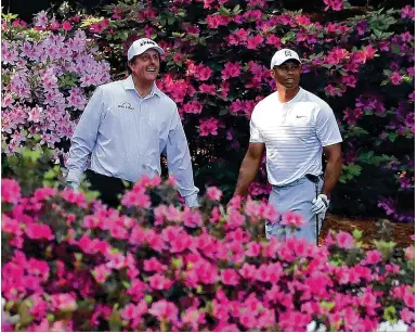  ?? CURTIS COMPTON / ATLANTA JOURNAL-CONSTITUTI­ON ?? Tiger Woods and Phil Mickelson have been great competitor­s but have also formed a friendship, which they showed off while playing a practice round together Tuesday at Augusta National.