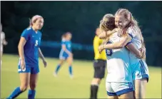  ?? Photo courtesy of JBU Sports Informatio­n ?? John Brown women’s soccer players Lauren Walter and Sienna Carballo embrace after a Lady Golden Eagles goal Monday in a 4-0 win against Oklahoma City in the semifinals of the Sooner Athletic Conference Tournament at Alumni Field.
