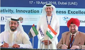  ?? — Photos by Dhes Handumon ?? Ahmed Sultan bin Sulayem signs an agreement with Lt Gen J.S. Ahluwalia, president, Institute of Directors, India, in the presence of Abdullah Al Saleh at the 2018 Dubai Global Convention on Tuesday.