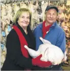  ??  ?? Angela Clay, from the Homeless Centre, collects a gift of turkeys from Tony Fleck