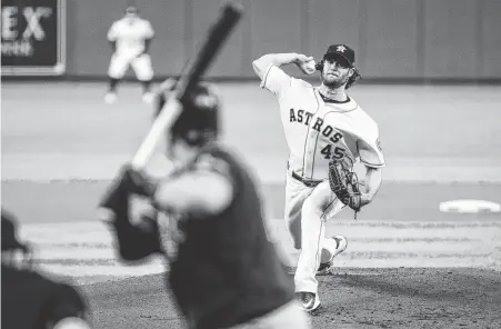  ?? Brett Coomer / Staff photograph­er ?? Gerrit Cole, who has won 17 straight decisions since last losing in May, became the seventh pitcher in MLB history with at least 15 strikeouts in a postseason outing when he beat the Rays in Game 2.