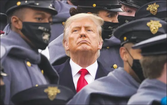  ?? ANDREW HARNIK / AP FILE (2020) ?? Surrounded by Army cadets, then-president Donald Trump watches the first half of the 121st Army-navy Football Game on Dec. 12, 2020, in Michie Stadium at the United States Military Academy in West Point, N.Y. Experts in constituti­onal law and the military say the Insurrecti­on Act gives presidents tremendous power with few restraints. Recent statements by former President Donald Trump raise questions about how he might use it if he wins another term.