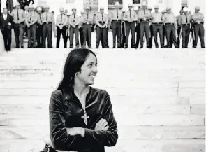  ?? Stephen Somerstein 1965 / Modernism, San Francisco ?? Baez, with state troopers arrayed across the state Capitol steps in Montgomery, Ala., on March 25, 1965, waits behind the speaker’s platform before singing to the 25,000 marchers after the Rev. Martin Luther King Jr.’s speech at the conclusion of the...