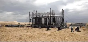  ??  ?? Workers prepare the stage for French electronic music pioneer Jean-Michel Jarre ahead of his upcoming concert to publicize the plight of the shrinking Dead Sea at the ancient cliff top fortress of Masada.