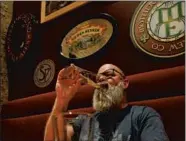  ?? RICK BOWMER/AP ?? Rob Wheatley drinks a beer at a Salt Lake City pub. The lowest DUI threshold takes effect this weekend in Utah.