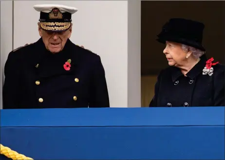  ??  ?? The Queen casts a concerned glance at a frail looking Duke of Edinburgh on the balcony of the Foreign Office while the couple watched the Remembranc­e Sunday service at the Cenotaph in Whitehall, London. Prince Charles laid a wreath on her behalf.