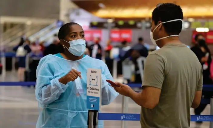  ?? Photograph: Lucy Nicholson/Reuters ?? Covid testing at LAX airport in Los Angeles. Health experts warned that infections and deaths will continue to soar in the coming weeks.