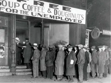  ??  ?? Unemployed men queue at ‘Big Al’s Kitchen for the Needy’ following the Wall Street Crash of 1929. The kitchen, run by the gangster Al Capone, fed about 3,500 people a day