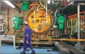  ?? REUTERS ?? A worker walks past a gas circulator in the turbine hall at EDF Energy's Hinkley Point B Nuclear Power Station in Bridgwater, southweste­rn England.