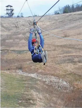  ?? LAKE GENEVA CANOPY TOURS ?? A zip liner flies over a repurposed gravel pit at Lake Geneva Canopy Tours.