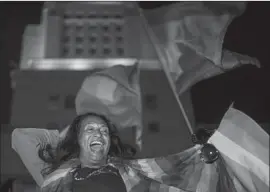  ??  ?? BRIGETTE CANALES, 51, of West Hollywood dances at the City Hall rally. L.A.’s LGBTQ leaders are alarmed at the administra­tion’s proposed policy change.