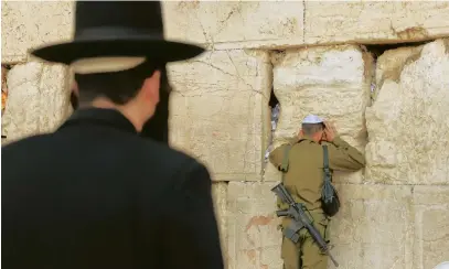  ?? (Marc Israel Selem/The Jerusalem Post) ?? ISRAELIS PRAY at the Western Wall during a service calling for the release of hostages from Gaza. A newfound closeness to God and Judaism has emerged among many Israelis.