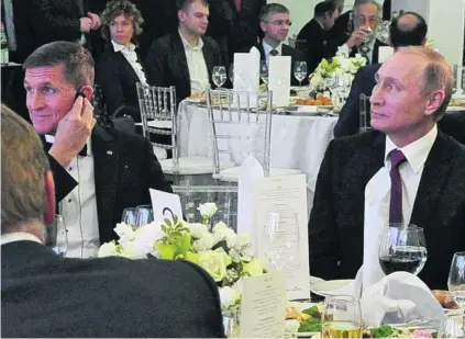  ?? Michael Klimentyev / EPA ?? Russian president Vladimir Putin and Michael Flynn at an event in Moscow 14 months ago.