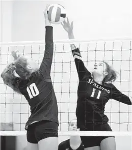  ?? BRIAN KRISTA/BALTIMORE SUN MEDIA GROUP ?? Annapolis Area Christian’s Skylar Emert, left, tries for a kill against Archbishop Spalding’s Terra Dzambo during a volleyball match Wednesday afternoon.