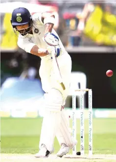  ?? — AFP photo ?? India’s batsman Virat Kohli hits a shot on the third day of the second cricket Test match between India and Australia in Perth.