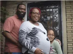  ?? (Erin Hooley/Chicago Tribune/TNS) ?? RACHAEL STEWART, who is pregnant and due April 10, stands outside her Chicago home with her daughter, Mya Moore, 8, and her husband, Clif Stewart.