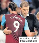  ??  ?? Andy Carroll with boss Slaven Bilic