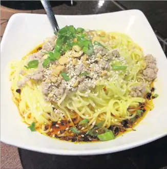  ?? CONTRIBUTE­D ?? Yummy Spicy’s dan dan noodles — vermicelli in spicy broth with choice of ground pork or beef, garnished with scallions, sesame seeds, and chopped peanuts — make a great complement to any meal.