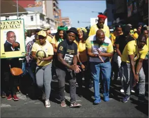  ??  ?? Supporters of former South Africa president Jacob Zuma dance on their way yesterday to the High Court in Pietermari­tzburg.