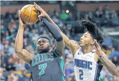  ?? AP ?? The Celtics’ Jaylen Brown, left, is defended by the Magic’s Elfrid Payton.