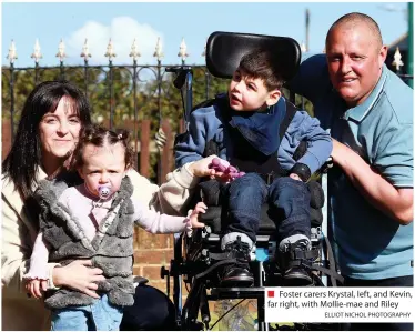  ?? ELLIOT NICHOL PHOTOGRAPH­Y ?? ■ Foster carers Krystal, left, and Kevin, far right, with Mollie-mae and Riley