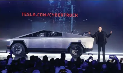  ??  ?? > Tesla CEO Elon Musk introduces the Cybertruck at Tesla’s design studio. See Question 3