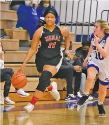  ?? STAFF PHOTO BY MATT HAMILTON ?? Signal Mountain’s Jaylah Hardy (11) dribbles down the court as Red Bank’s Tanya Guye (10) gives chase on Tuesday at Red Bank High School.