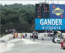  ?? THE ASSOCIATED PRESS ?? Track workers repair the fence at Pocono Raceway after a crash involving Canadian IndyCar driver Robert Wickens.