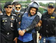  ?? (AP/Sourav Lasker) ?? Mohammed Shahed (center), owner of two hospitals that issued thousands of fake coronaviru­s test reports, is arrested Wednesday in Dhaka, Bangladesh.