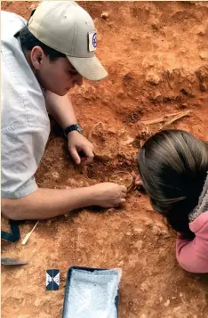  ??  ?? Below: Excavating an enamelled copper-alloy bowl in 2019