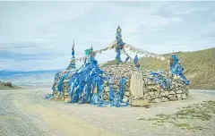  ??  ?? A Mongol ovoo, a sacred stone heap used as an altar or shrine in folk religious practices, in Khovd province.