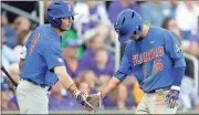  ?? Nati Harnik / The Associated Press ?? Florida’s Dalton Guthrie (right) and Jonathan India celebrate during Monday’s game against LSU.